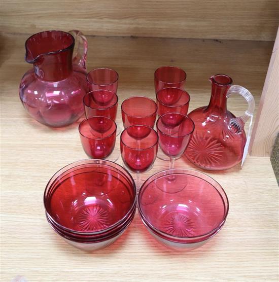 A quantity of 19th century cranberry glass including two jugs and eight glasses, six finger bowls, etc.